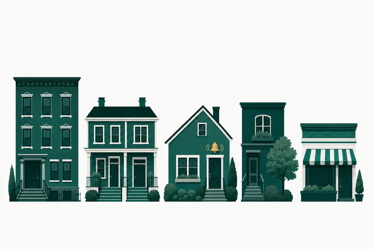 A row of small evergreen-green rental buildings, with a brass bell ringing above one doorway